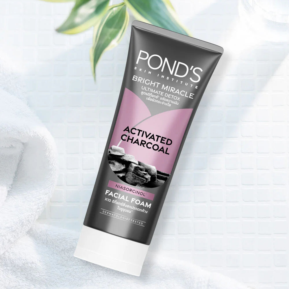 Woman using Pond's charcoal facial foam demonstrating rich creamy lather massage technique for deep detox cleansing benefits