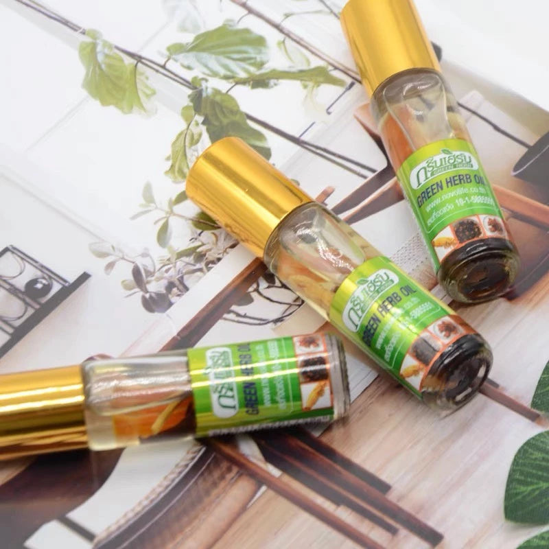 Person holding Green Herb Oil with Ginseng 8cc near nose inhaling herbal aroma