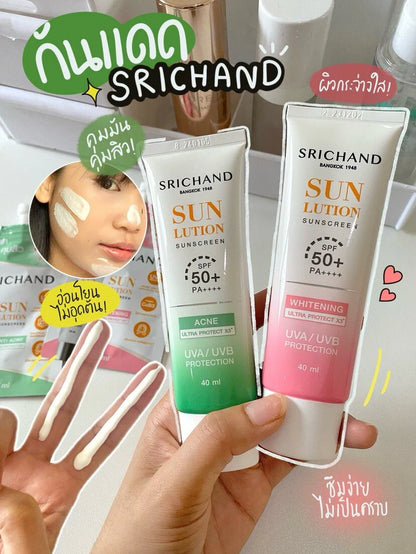 Asian woman applying Srichand acne care sunscreen demonstrating lightweight application technique for acne-prone skin protection