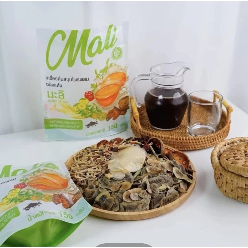 Woman preparing Malee Herbal Tea traditional brew or instant citrus orange flavor for gentle digestive wellness relief