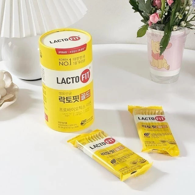 Woman taking Lacto-Fit Probiotic Gold Upgrade for balanced gut strong immunity radiant wellness