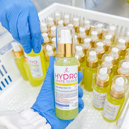 Woman applying ZQUEEN Hydro White Dose serum directly to arms and legs as a concentrated body brightening treatment morning and evening